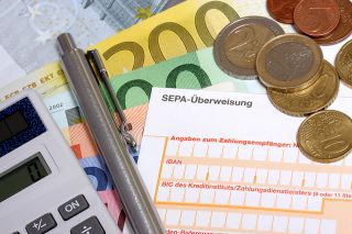 Foto: Erlagschein und Münzen